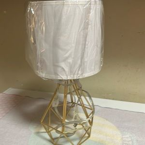 Gold pyramid lamp with white lamp shade